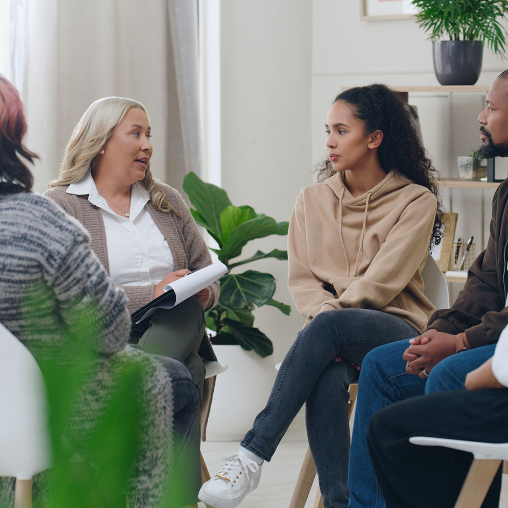 Diversity, mental health and group therapy counseling support meeting, healthy conversation and wellness. Psychology counselor, psychologist help people and talk about anxiety, depression or stress.