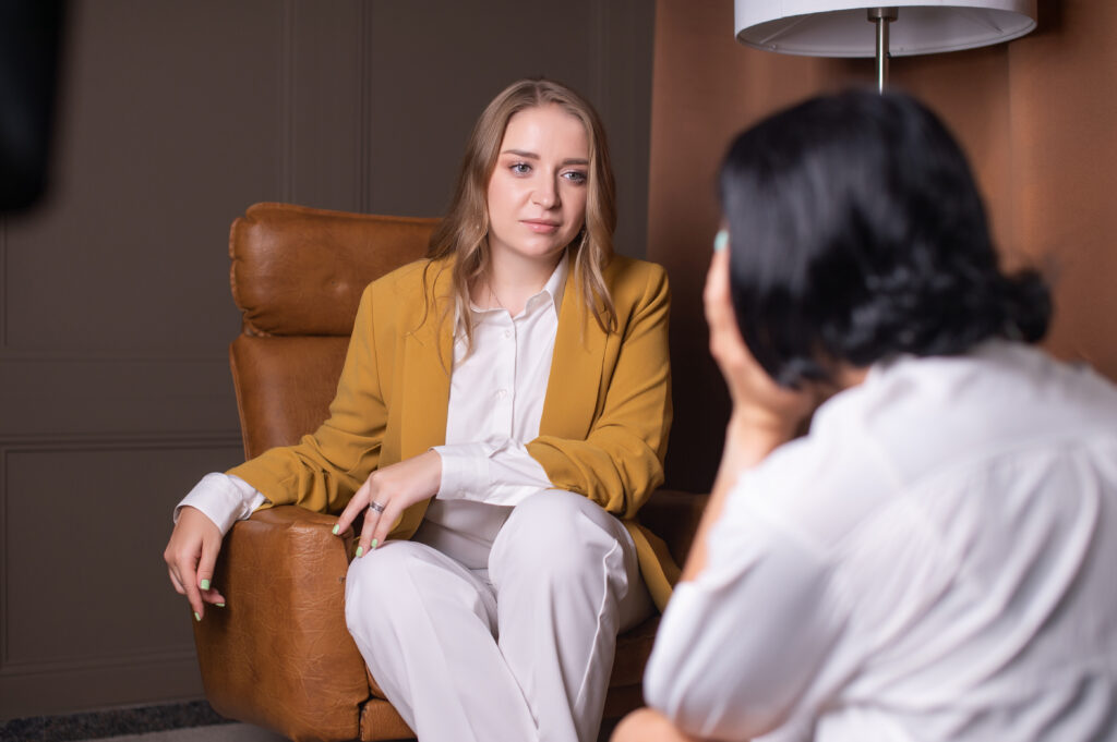 A nice woman psychologist helps to solve the emotional experiences of the client