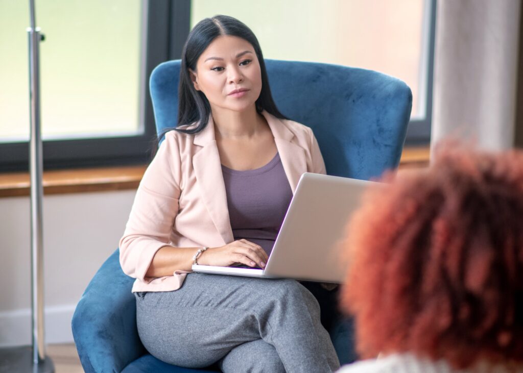 Psychoanalyst listening. Experienced dark-haired psychoanalyst listening to her client attentively