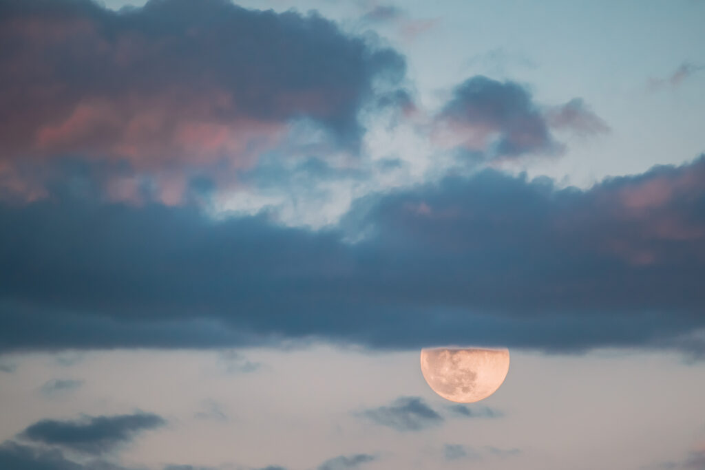 Full Moon Rising In Cloudy Evening Sky. Full Moon Rising In Cloudy Evening Sky.