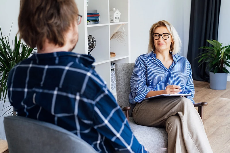 A person participates in therapy at a drug rehab center.